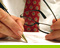 Man writing and holding reading glasses
